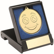 BLACK PLASTIC BOX WITH 50mm GOLD SMILEY FACE MEDAL TROPHY - 3.5in